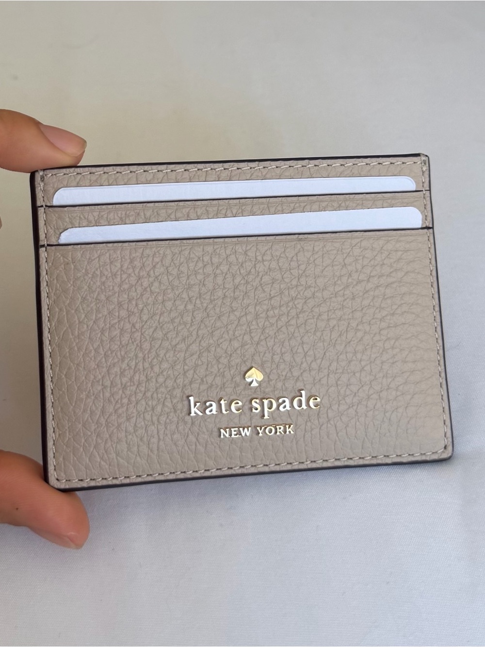 kate spade taupe pebbled leather card case with gold logo